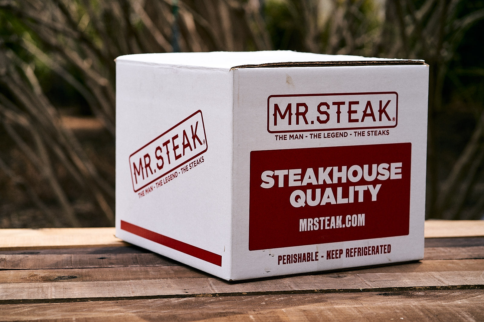 Various Mr. Steak brand steaks with Mr. Steak brand seasonings beside
