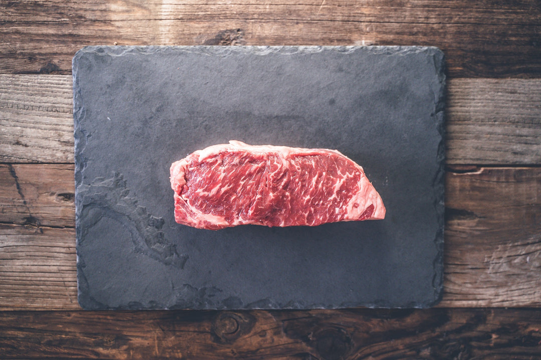 Juicy and well-marbled raw New York Strip