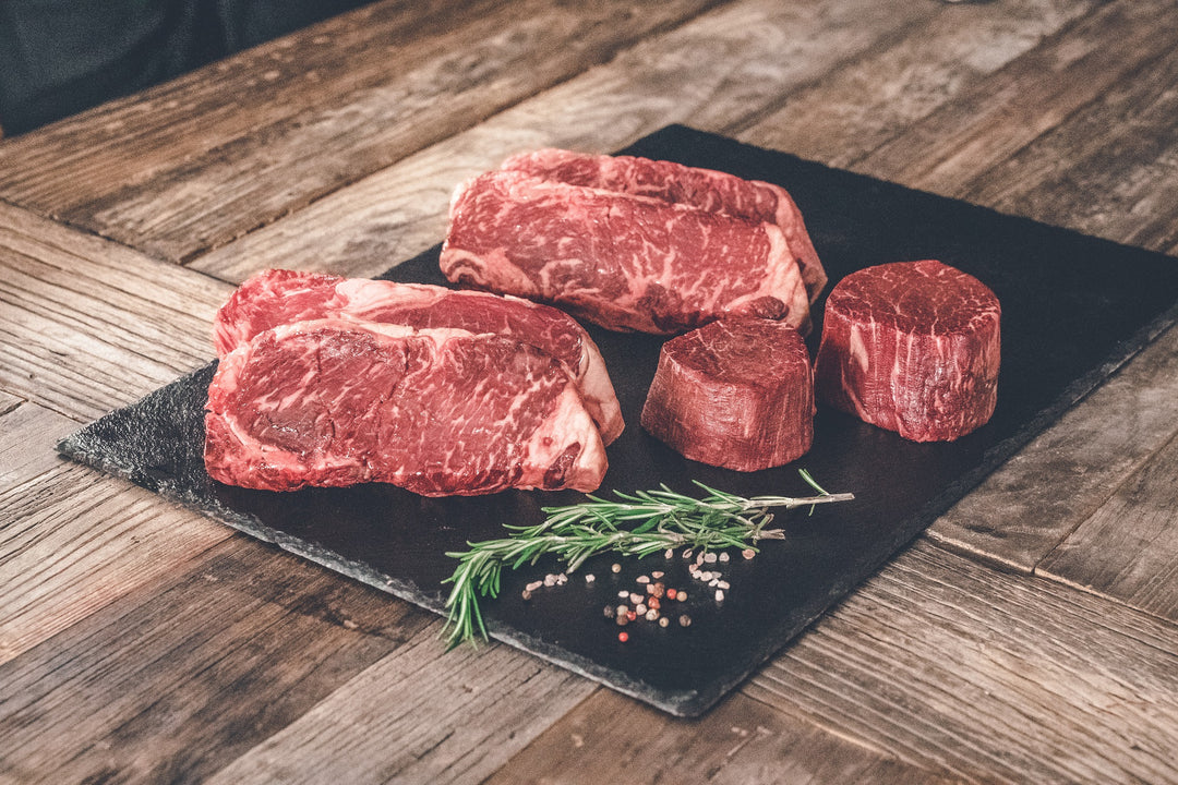 Assortment of USDA Prime steaks - Boneless Ribeye, boneless New York Strip, and 2 Filet Mignons