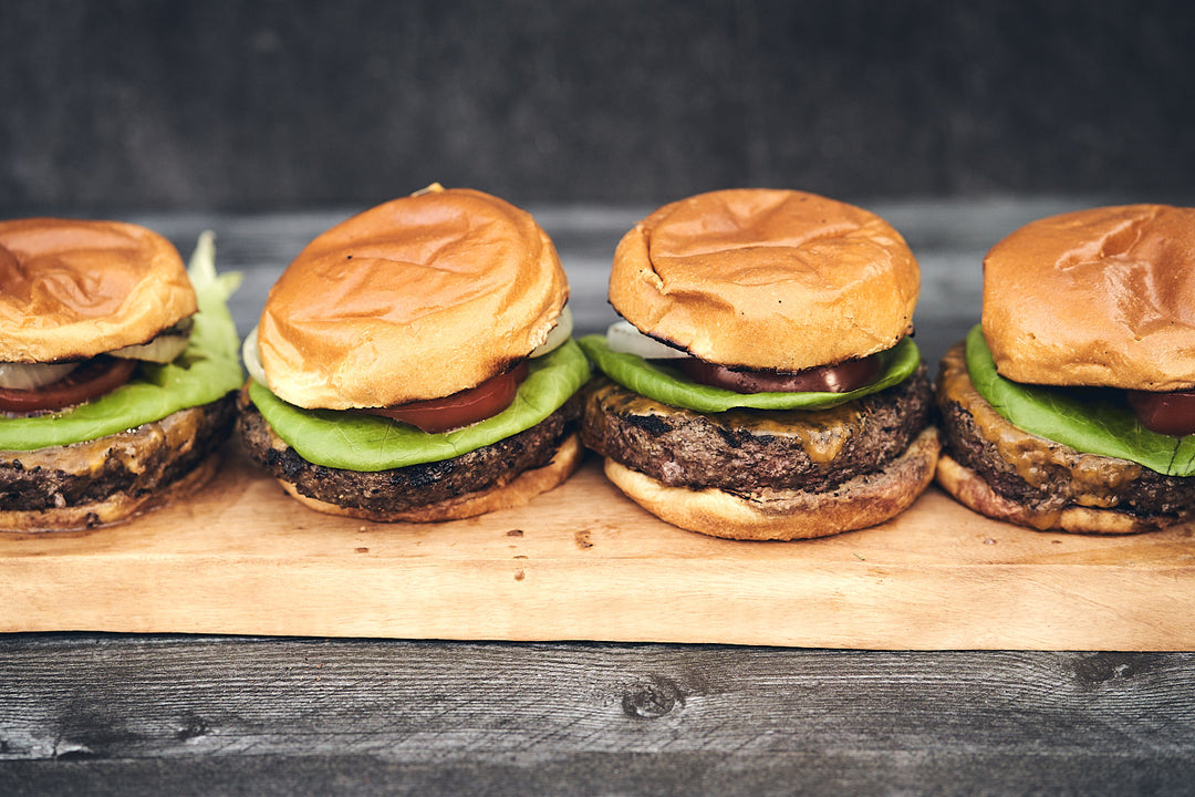 Four Mr. Steak cheeseburgers with tomato and lettuce
