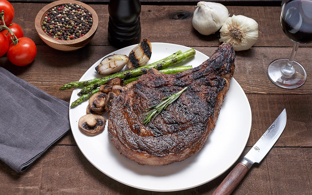 Stunning American Wagyu ribeye cut, cooked to perfection, with a side of mushrooms and asparagus 
