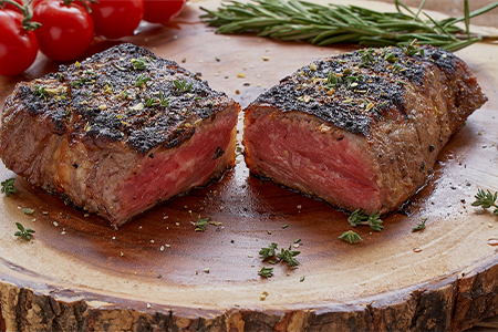 Beautifully cooked and seasoned New York Strip, cut in half to show the colouring